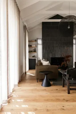 a living room with a couch and a table at Tide and Timber Luxury Guesthouse in Hermanus