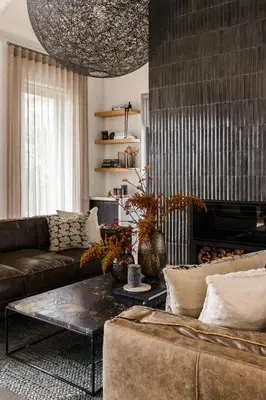a living room with a couch and a coffee table at Tide and Timber Luxury Guesthouse in Hermanus