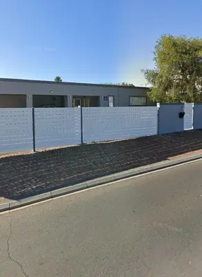 a white fence on the side of a road at Cozy and convenient in Oakdale