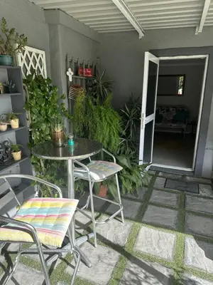 a patio with a table and chairs and plants at Cozy and convenient in Oakdale