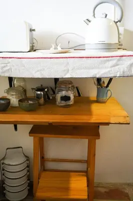 a shelf in a kitchen with pots and pans at The Little Gallery in Villiersdorp