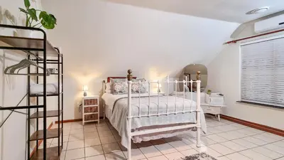 a bedroom with a white bed and a window at Rivers Edge Loft in Wellington