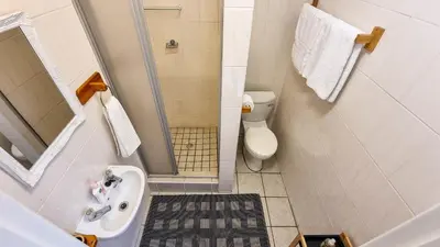 a small bathroom with a sink and a toilet at Rivers Edge Loft in Wellington
