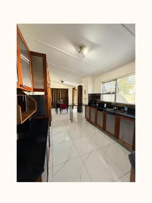 a large room with a kitchen and a dining room at Rihla Residences - Civic Road in Cape Town