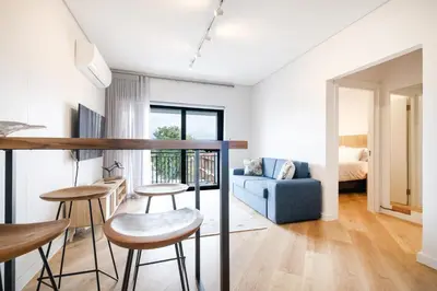 a living room with a couch and a table and chairs at Paarl - Lux Modern 2 Bedroom Apartment with Parking in Paarl