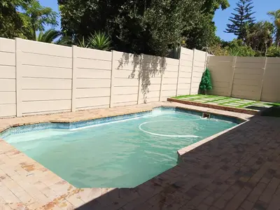 a swimming pool in a backyard with a fence at Duminy Lodge Monthly Rentals in Bellville