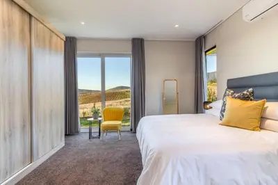 a bedroom with a large bed and a large window at Modern Home with Views, Pool & Fireplaces in Estate in the Wineland