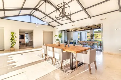 a dining room with a wooden table and chairs at Modern Home with Views, Pool & Fireplaces in Estate in the Wineland