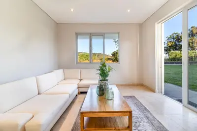 a living room with a white couch and a coffee table at Modern Home with Views, Pool & Fireplaces in Estate in the Wineland