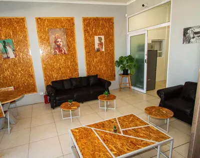a living room with two couches and a table at Lodge Luxe, Cozy Bedrooms, Free WiFi, Robust Security in Cape Town