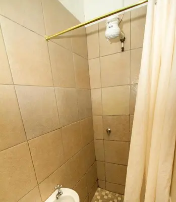a bathroom with a toilet and a shower curtain at Lodge Luxe, Cozy Bedrooms, Free WiFi, Robust Security in Cape Town