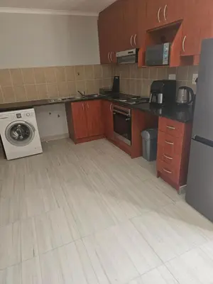 a kitchen with a washer and dryer in it at 180 Mont Blanc in Gordonʼs Bay