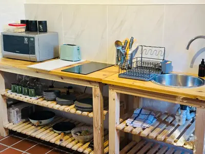 a kitchen counter with a sink and a microwave at 3 Uitsig Street, Rozendal, Stellenbosch in Stellenbosch