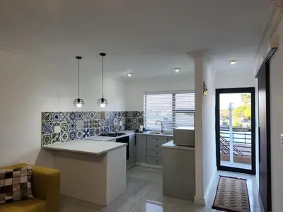 a kitchen with a sink and a counter top at G's Apartments Cape Town in Windsor Park