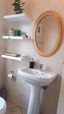 a bathroom with a sink and a mirror at Entire 2 Level Townhouse in Backenfell Cape Town in Brackenfell
