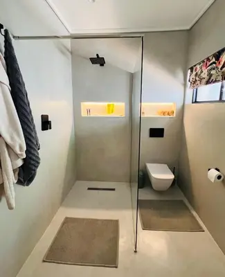 a bathroom with a shower and a toilet at Villa Victoria in Paarl