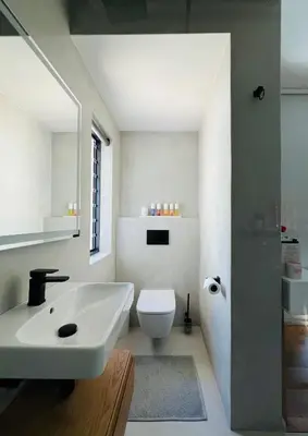 a white bathroom with a sink and a toilet at Villa Victoria in Paarl