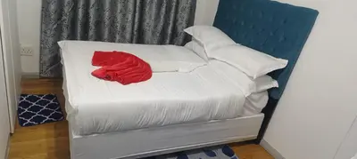 a red blanket on a bed with white pillows at PEACEFUL SLEEP lodge 1 in Goodwood