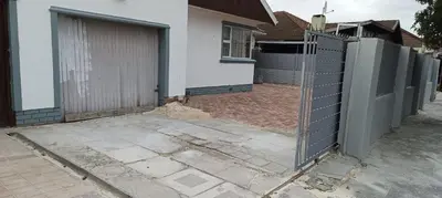 a fence in front of a house at PEACEFUL SLEEP lodge 1 in Goodwood