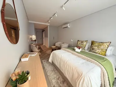 a bedroom with a large bed and a mirror at Platform 133 2 Tabak in Paarl