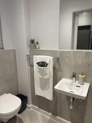 a bathroom with a white toilet and a sink at Platform 133 2 Tabak in Paarl