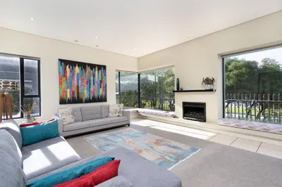 a living room with a couch and a fireplace at Villa on 15th Waters Edge, Cape Town in Cape Town