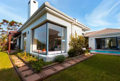 a house with a large window in a yard at Villa on 15th Waters Edge, Cape Town in Cape Town