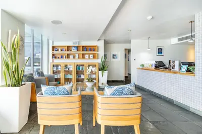a dining room with chairs and a table at 2 Bedroom Seaview, Holiday Apartment, Lagoon Beach in Cape Town