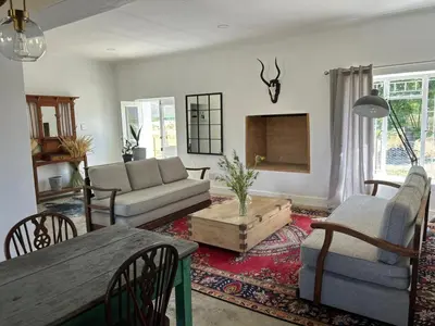 a living room with a couch and a table at Ceres Hideaways