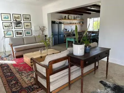 a living room with a table and a couch at Ceres Hideaways
