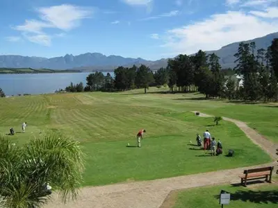 a group of people playing golf on a golf course at Fairway Corner in Villiersdorp