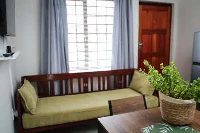 a couch sitting in a living room with a table at Schutterend in Nieuwe Drift