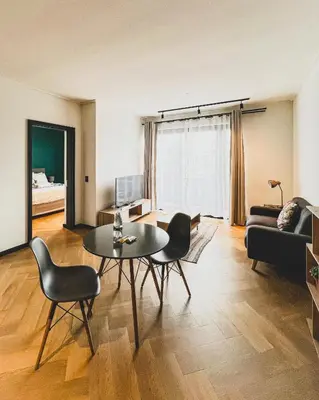 a living room with a table and chairs and a couch at 1bedroom Luxe Nine Palms near Canal Walk in Cape Town