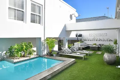a swimming pool in the backyard of a house at Le Petit Bijou Aparthotel in Franschhoek