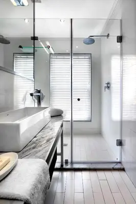 a white bathroom with a tub and a shower at Le Petit Bijou Aparthotel in Franschhoek