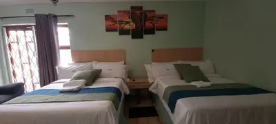 a room with two beds in a room at Ojong's Self-Catering Ridgeworth - Bellville in Tyger Valley