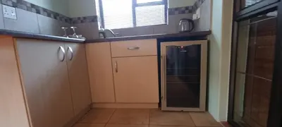 a small kitchen with a sink and a dishwasher at Ojong's Self-Catering Ridgeworth - Bellville in Tyger Valley
