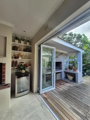 a room with a sliding glass door and a deck at Serendipity 2 Bedroom Family Home in Onrus in Hermanus