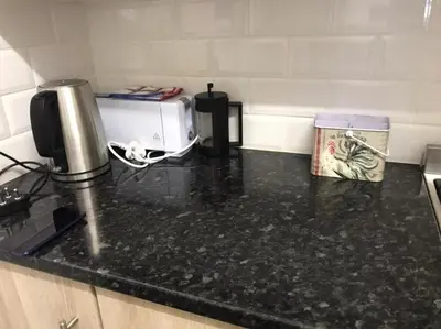 a kitchen counter with a toaster on a counter top at Sunny Spacious Stellenbosch 3 bed garden apartment in Stellenbosch