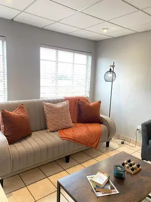 a living room with a couch and a table at Nunu's Self Catering Apartment in Paarl