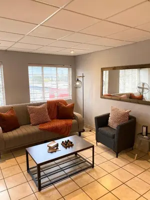 a living room with a couch and a coffee table at Nunu's Self Catering Apartment in Paarl
