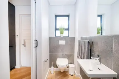 a bathroom with a white toilet and a sink at Paarl 137 - Superior Studio Apartment with AC and Parking in Paarl