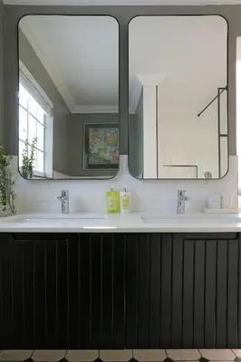 a bathroom with two sinks and a mirror at Seabreeze Retreat in Hermanus