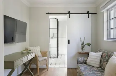 a living room with a couch and a table at Seabreeze Retreat in Hermanus