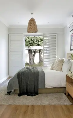 a bedroom with a large bed with a window at Seabreeze Retreat in Hermanus