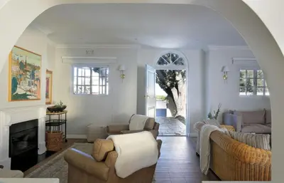 a living room with two couches and a fireplace at Seabreeze Retreat in Hermanus
