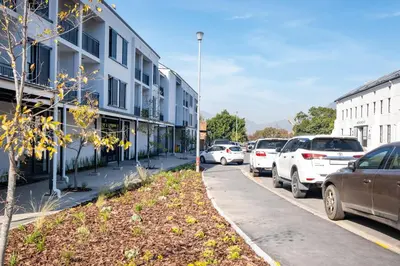 a street with cars parked on the side of a building at Paarl Studio 138 - Ultra Modern Apartment with AC and onsite Parking in Paarl