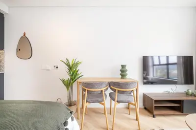 a bedroom with a table and two chairs at Paarl Studio 138 - Ultra Modern Apartment with AC and onsite Parking in Paarl