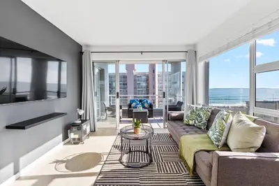 a living room with a couch and a table at Ocean View B503 in Cape Town