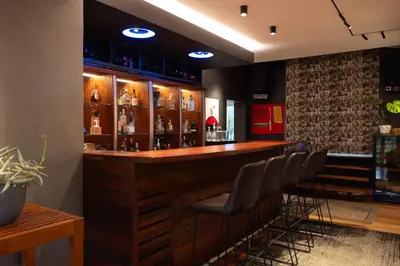 a bar with a row of stools in a room at Stellenbosch Farm Stay with Mountain Views & Pool in Stellenbosch